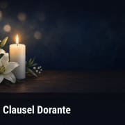 Fostoria News Memorial candle with white lilies for Clausel Dorante obituary.